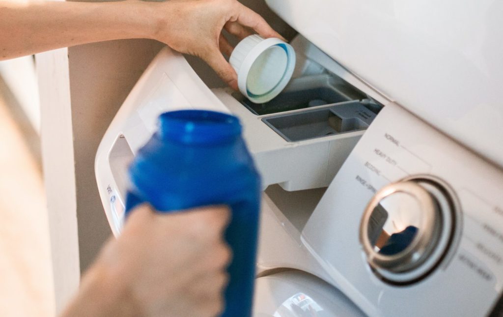 Pouring detergent into Washer